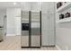 A stainless steel refrigerator stands beside gray cabinets and above wood floors, offering ample storage and style at 4101 Brooke Dr, Valrico, FL 33594