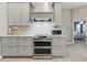 Stylish kitchen with gray cabinets, stainless steel oven, and a modern backsplash at 4101 Brooke Dr, Valrico, FL 33594