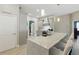 Open concept kitchen featuring a large island with seating, modern lighting, stainless appliances, and a nearby laundry room at 4101 Brooke Dr, Valrico, FL 33594