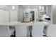 Open kitchen features a large island with seating, modern lighting, and stainless steel appliances at 4101 Brooke Dr, Valrico, FL 33594