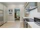 Modern kitchen featuring stainless steel appliances, gray cabinetry, stylish backsplash, and wood look floors at 4101 Brooke Dr, Valrico, FL 33594