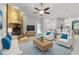 The living room features a brick fireplace, ceiling fan, and plenty of seating in an open concept design at 4101 Brooke Dr, Valrico, FL 33594