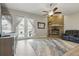 The spacious living room has a brick fireplace, ceiling fan, and french doors leading to the backyard and pool at 4101 Brooke Dr, Valrico, FL 33594