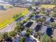 Aerial view of home in a neighborhood near a green field and residential streets at 441 Thicket Crest Rd, Seffner, FL 33584