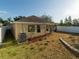 Exterior view of a house showcasing a landscaped backyard with fresh mulch and budding trees at 441 Thicket Crest Rd, Seffner, FL 33584