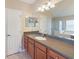 Well-lit main bathroom showcasing a double vanity, a soaking tub, a separate shower, and ample cabinet space at 441 Thicket Crest Rd, Seffner, FL 33584