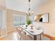 Cozy dining room with a modern chandelier and neutral decor at 441 Thicket Crest Rd, Seffner, FL 33584