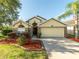 Charming home with stone accents, lush landscaping, and a well-manicured lawn at 441 Thicket Crest Rd, Seffner, FL 33584