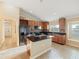 Bright kitchen features an island, wood cabinets, and a view of the front yard at 441 Thicket Crest Rd, Seffner, FL 33584