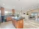 Open kitchen featuring a central island, stainless steel appliances, and tile backsplash at 441 Thicket Crest Rd, Seffner, FL 33584