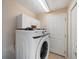 Laundry room with front load Samsung washer and dryer and white cabinets for storage at 441 Thicket Crest Rd, Seffner, FL 33584