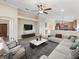 Open-concept living room showcasing a large sectional sofa, a modern entertainment center, and an eat-in kitchen at 441 Thicket Crest Rd, Seffner, FL 33584