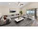 Bright living room featuring a vaulted ceiling, modern furniture, and sliding glass doors to the backyard at 441 Thicket Crest Rd, Seffner, FL 33584
