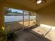A shaded screened patio with a ceiling fan overlooking a fenced backyard at 441 Thicket Crest Rd, Seffner, FL 33584