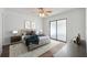Spacious primary bedroom featuring a ceiling fan, neutral decor, and sliding glass doors at 4935 42Nd N Pl, St Petersburg, FL 33709