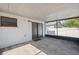 Enclosed patio with a white brick wall, black sliding door and concrete flooring at 4935 42Nd N Pl, St Petersburg, FL 33709