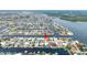 Aerial view of waterfront community with canals, docks, and homes by the water and lush greenery at 5008 Southshore Dr, New Port Richey, FL 34652