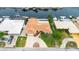 Aerial view of a waterfront property with a terracotta roof, circular driveway and a private dock at 5008 Southshore Dr, New Port Richey, FL 34652