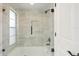 Updated bathroom with tiled walls, glass shower door and black shower fixtures at 5008 Southshore Dr, New Port Richey, FL 34652
