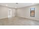 Bright bedroom with a neutral color scheme, tile floors, and a window for natural light at 5008 Southshore Dr, New Port Richey, FL 34652