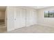 Bedroom featuring a large window and closet with sliding louvered doors at 5008 Southshore Dr, New Port Richey, FL 34652