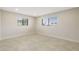 Sunny bedroom with tile floors and two windows that provide ample natural light at 5008 Southshore Dr, New Port Richey, FL 34652