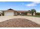 Home featuring a terracotta roof, stone accents, and a circular driveway leading to the attached garage at 5008 Southshore Dr, New Port Richey, FL 34652