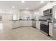 Open-concept kitchen with stainless steel appliances and bar seating at 5008 Southshore Dr, New Port Richey, FL 34652