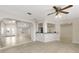 Living room with tile floors, ceiling fans, and access to the kitchen at 5008 Southshore Dr, New Port Richey, FL 34652