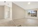 Bright, open living room with neutral paint, tile flooring and a large window at 5008 Southshore Dr, New Port Richey, FL 34652