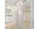 Walk-in closet featuring double sliding doors, built-in shelving, and plenty of storage space at 5008 Southshore Dr, New Port Richey, FL 34652