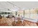 Enclosed living room features a ceiling fan, tiled floors, many windows, and natural light at 5708 Ridgestone Dr, Tampa, FL 33625