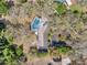 Birds eye view of the property featuring pool, house, and circular driveway with landscaping at 6514 Sunhigh Dr, New Port Richey, FL 34655