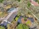 Aerial view of property highlighting circular driveway, landscaping and screened-in pool at 6514 Sunhigh Dr, New Port Richey, FL 34655