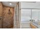 The bathroom features a tiled shower and natural light via access to the large picture window at 6514 Sunhigh Dr, New Port Richey, FL 34655