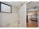 Bathroom featuring a tiled bathtub with shower, window, and access to the bedroom, offering a clean and functional space at 6514 Sunhigh Dr, New Port Richey, FL 34655