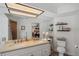 The bathroom features a large mirror, neutral countertops, and access to the main bedroom and shower at 6514 Sunhigh Dr, New Port Richey, FL 34655