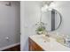 Bathroom featuring a vanity with a round mirror, modern fixtures, and ample counter space, creating a spa-like experience at 6514 Sunhigh Dr, New Port Richey, FL 34655