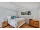 Bedroom features a comfortable bed, hardwood floors, ceiling fan, and natural light, creating a serene atmosphere at 6514 Sunhigh Dr, New Port Richey, FL 34655