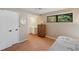 Bedroom with hardwood floors, ensuite bath, walk-in closet, and a large window at 6514 Sunhigh Dr, New Port Richey, FL 34655