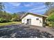 Exterior view of detached garage with separate entrance, surrounded by mature landscaping at 6514 Sunhigh Dr, New Port Richey, FL 34655