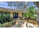 Inviting home exterior featuring a charming front entrance with double doors and lush landscaping at 6514 Sunhigh Dr, New Port Richey, FL 34655