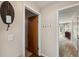 Hallway view of a door and view into the carpeted living room at 6514 Sunhigh Dr, New Port Richey, FL 34655