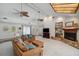Open living room with vaulted ceiling, fireplace, built-in shelving, and comfortable seating, perfect for entertaining guests at 6514 Sunhigh Dr, New Port Richey, FL 34655