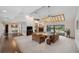 Open living room featuring a fireplace, beamed ceilings, and seamless access to the outdoor pool area at 6514 Sunhigh Dr, New Port Richey, FL 34655