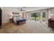 Spacious main bedroom with plush carpet, ceiling fan, and access to the outdoors at 6514 Sunhigh Dr, New Port Richey, FL 34655