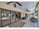 Covered patio with ceiling fans offers a relaxing outdoor space for dining and entertaining with a view of the pool at 6514 Sunhigh Dr, New Port Richey, FL 34655