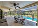 Covered patio with a view of the pool and backyard, perfect for outdoor dining and relaxation at 6514 Sunhigh Dr, New Port Richey, FL 34655