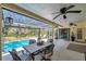 Spacious covered patio featuring a dining area and screened pool view, ideal for outdoor living at 6514 Sunhigh Dr, New Port Richey, FL 34655