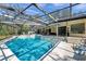 Inviting screened pool with tiled border, seamlessly connecting to the home's outdoor living space at 6514 Sunhigh Dr, New Port Richey, FL 34655